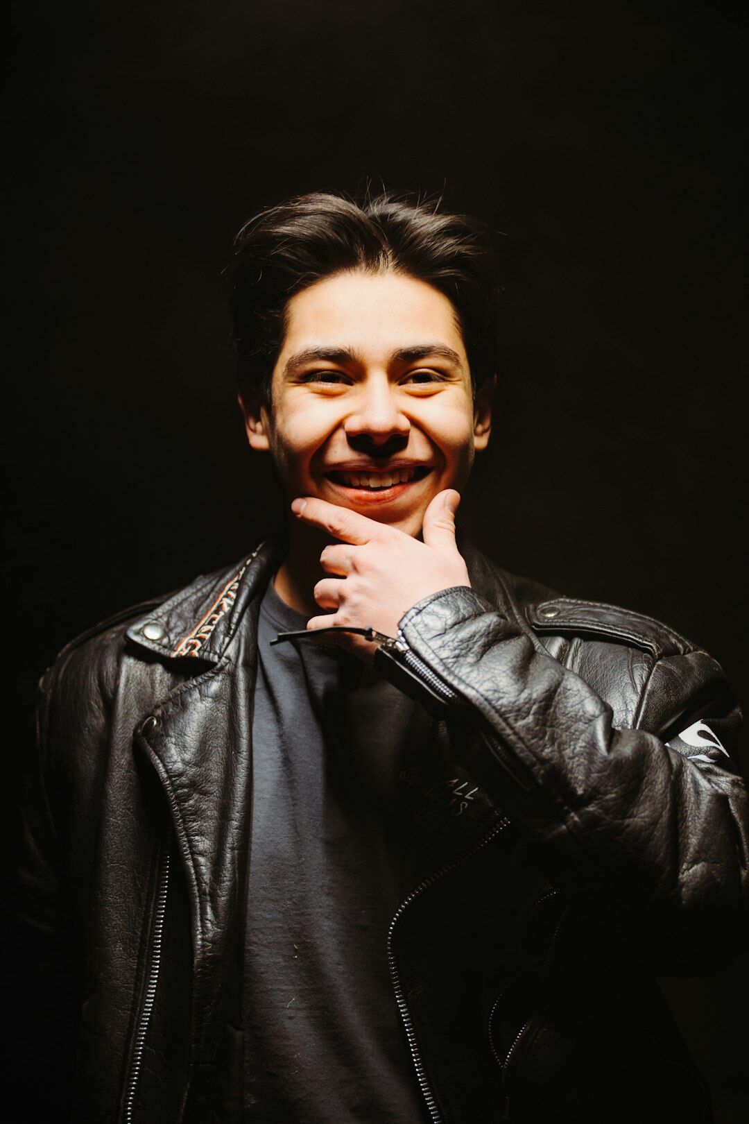 Studio portrait of a smiling man in a jacket