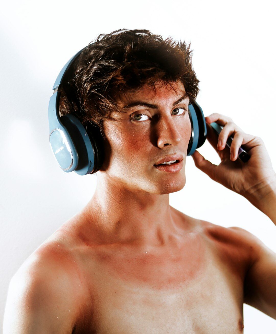 Studio portrait of a man with short hair wearing headphones