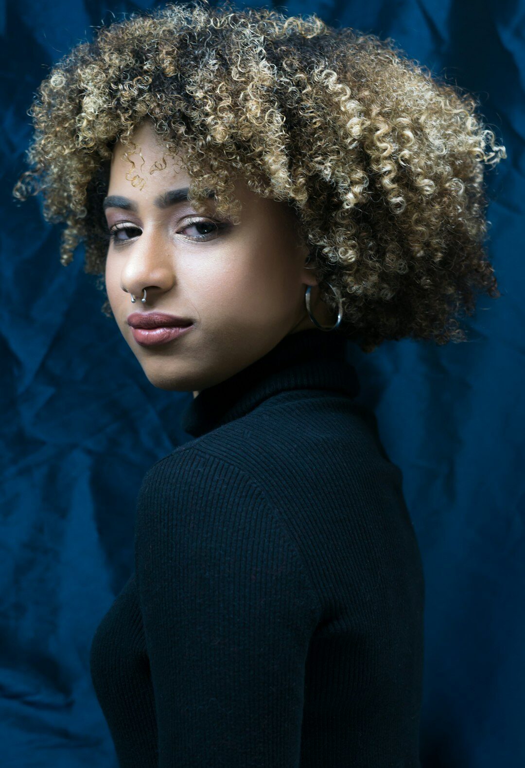 Studio portrait of a young woman with curly hair